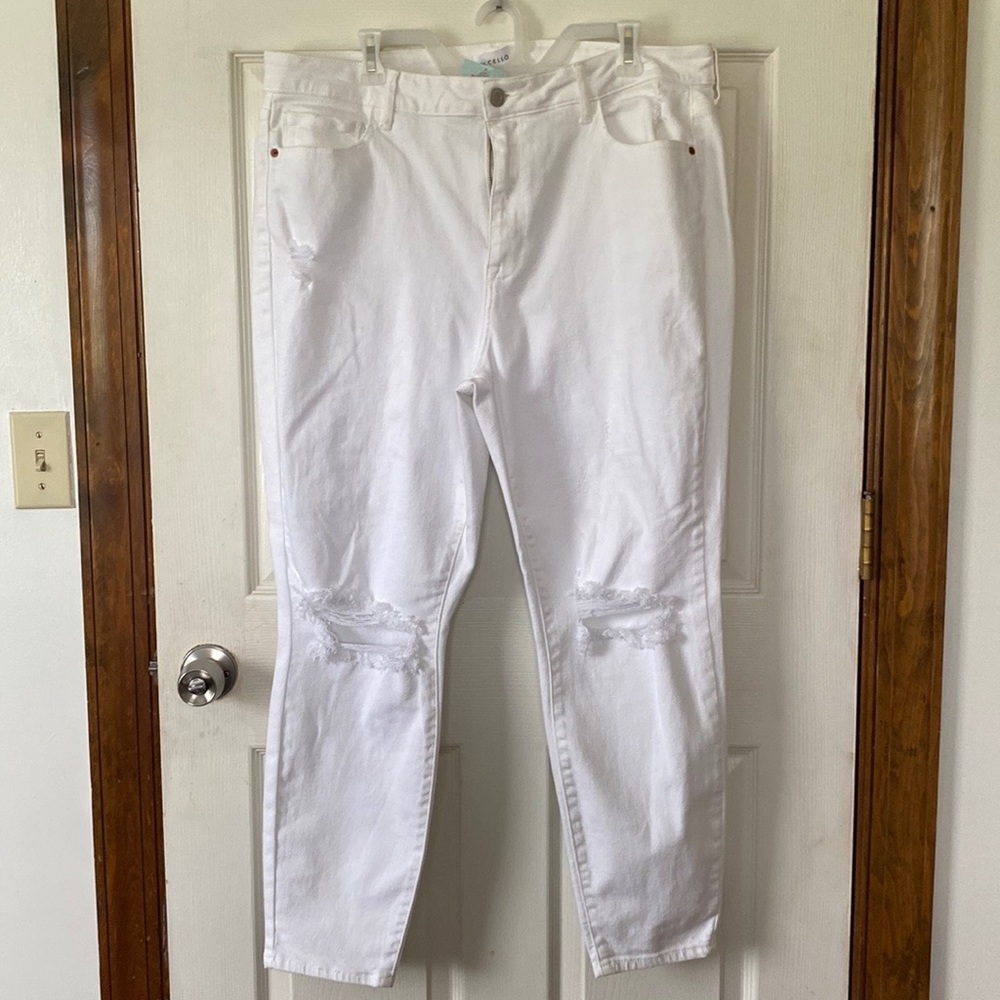 White jeans with rips in the knees, high rise, and skinny. Ms. Cello brand.